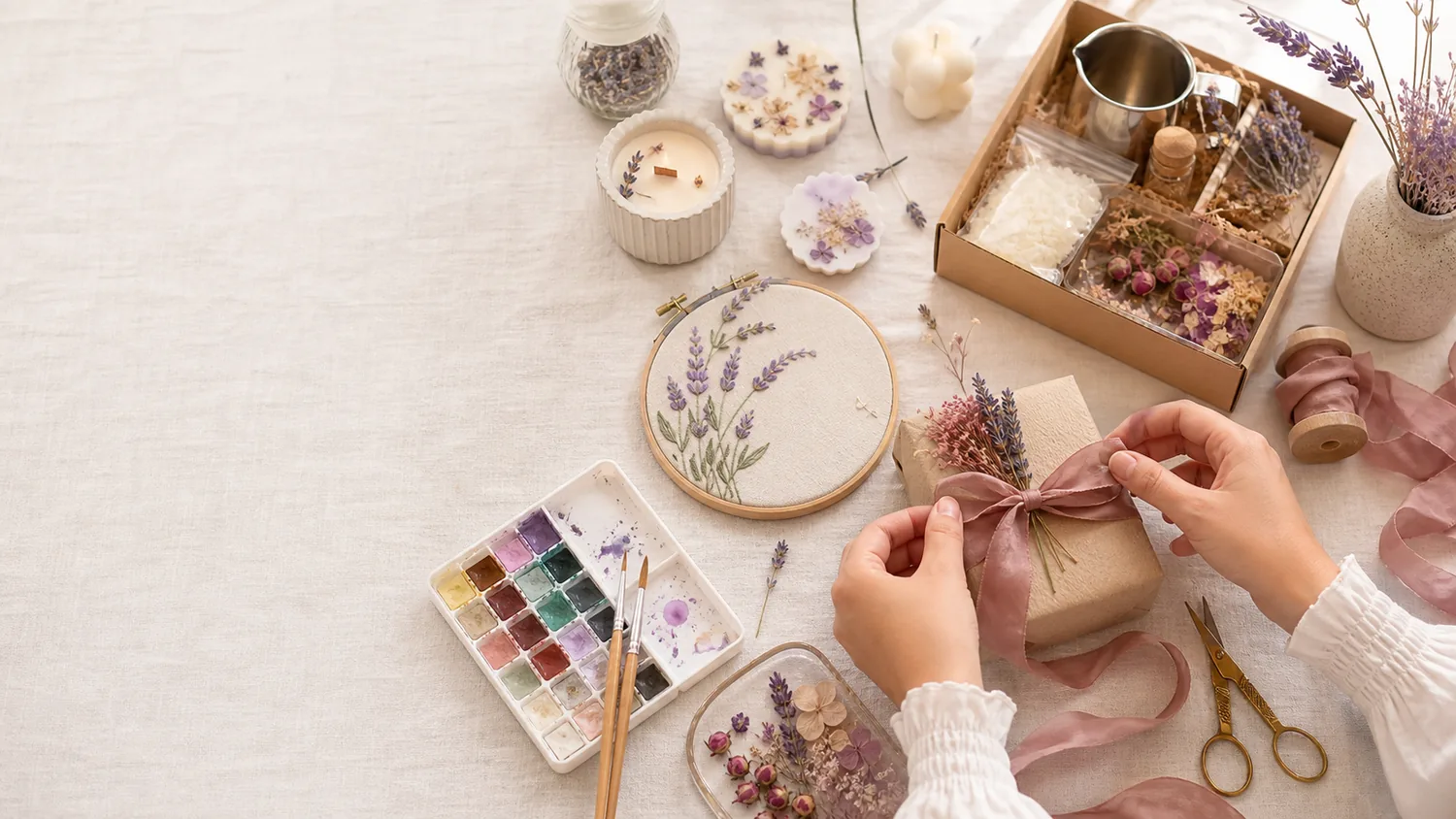 A warm craft table with candle making, embroidery and pressed flowers